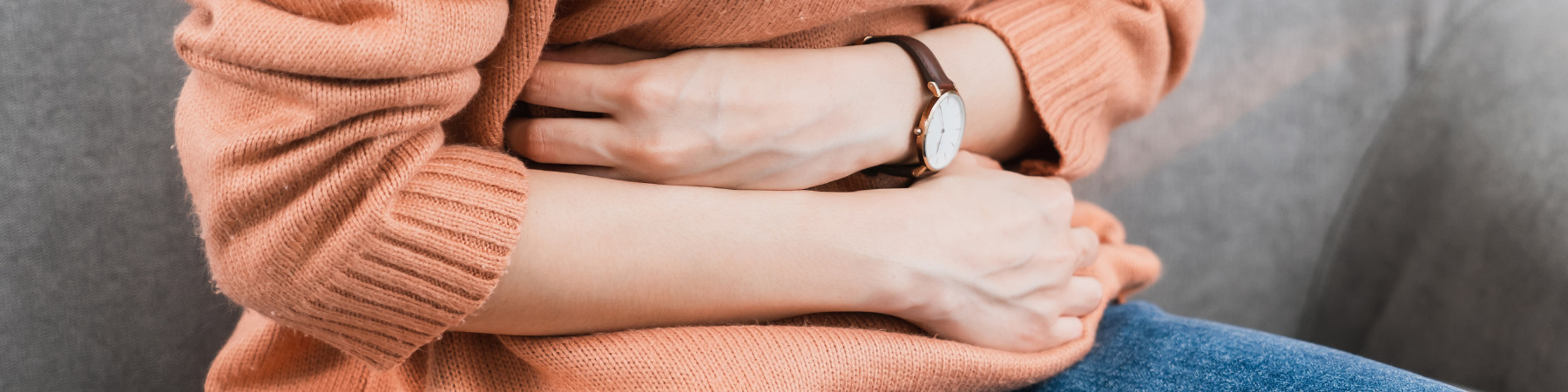 woman putting her hands on her stomach