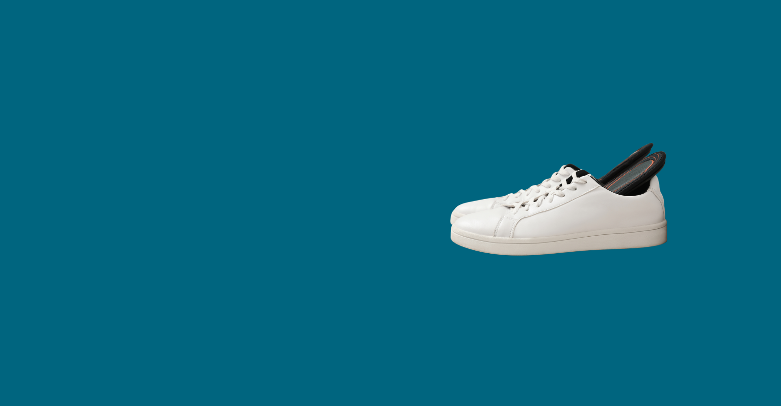 orthopaedic insoles in shoes on blue background